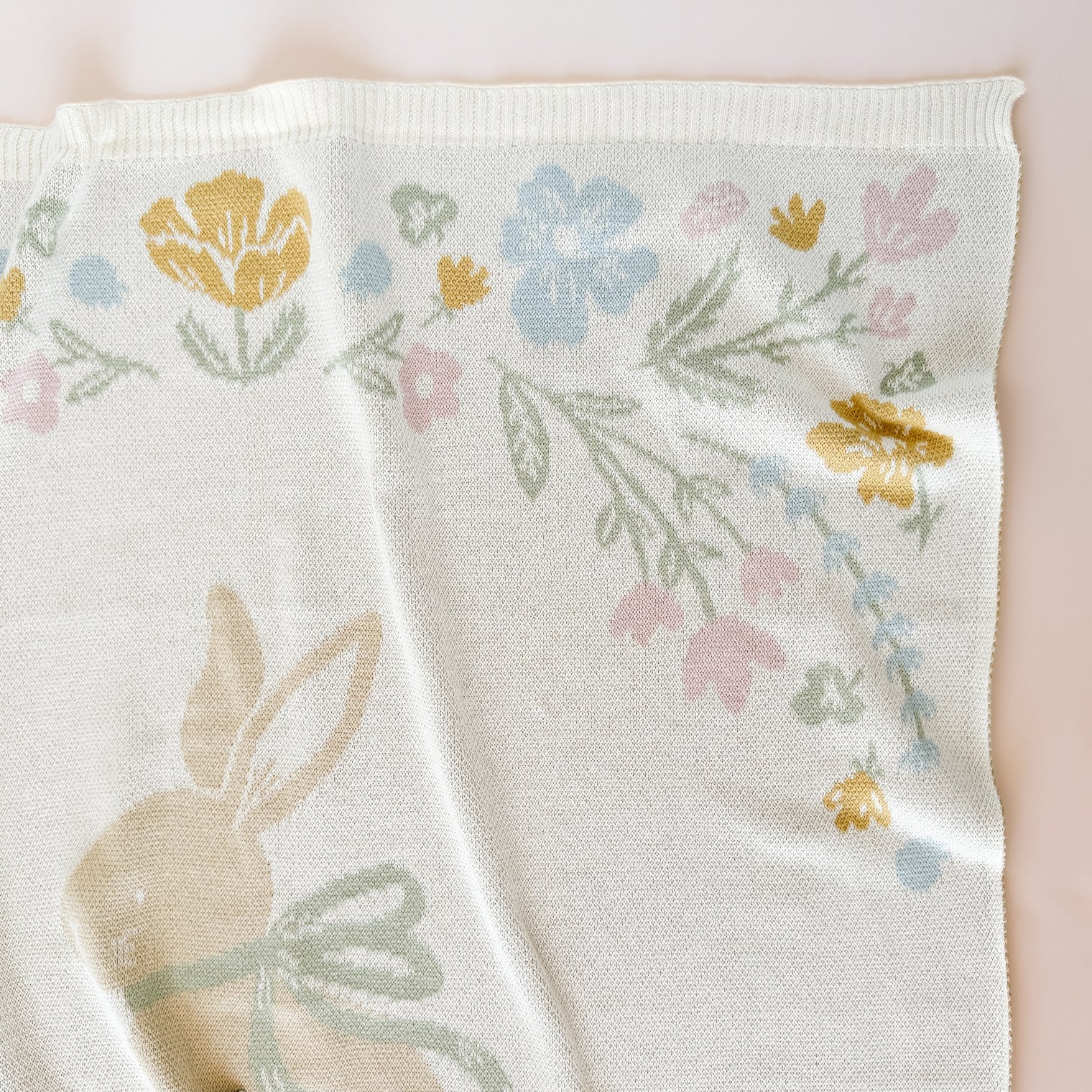 This organic cotton floral blanket centers around a sweet bunny with a bow. Snuggle in it. Decorate with it. Get the matching bunny lovey, baby rattles, or greeting card to complete the gift set. 
