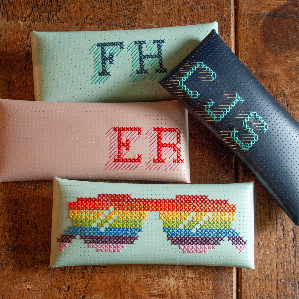 Stitch your own way - this envelope pocket is ideal as a pencil or glasses case and allows you to sew any unique design. Whether you stitch initials, a slogan or the sunglasses template included, it opens out fully for easy stitching. It also opens 2 ways, so it can open from the side or from the top - just pop the metal buttons to fold up whichever way you prefer. The Navy pouch comes with teal & gold thread &amp; needle wrapped on our pen thread-board. It includes our 3D alphabet template to add initials