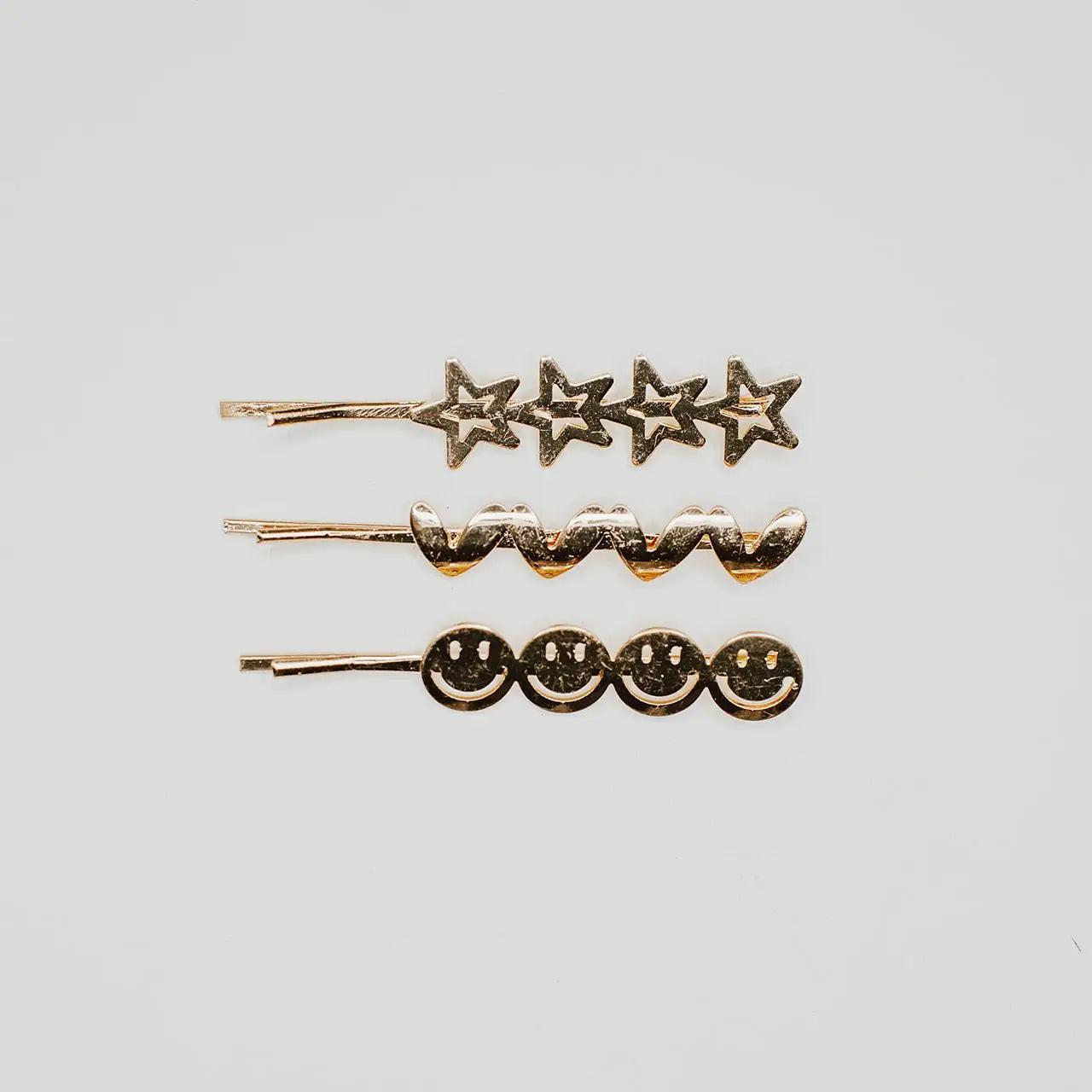 Why settle for boring, old bobby pins, when you could have these True JOY Bobbies from Denim &amp; Daisy! Three gold bobbies Light years better than your everyday, ordinary bobby pins Find these bobby pins only at Denim &amp; Daisy These gold-colored bobby pins feature cute hearts, stars, and smiley faces, taking a normally ordinary, mundane hair accessory to the next level. You’ll only find the True JOY Bobbies at Denim &amp; Daisy. Order yours today.
