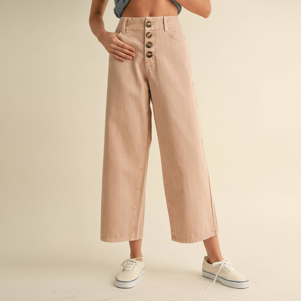 Classic cotton pants with a refined button front detail. Crafted from soft, breathable cotton for everyday comfort and versatility. The tailored fit flatters while allowing ease of movement, making these pants perfect for casual outings or dressed-up occasions. Available in a sophisticated mauve tone that pairs effortlessly with any wardrobe staple.