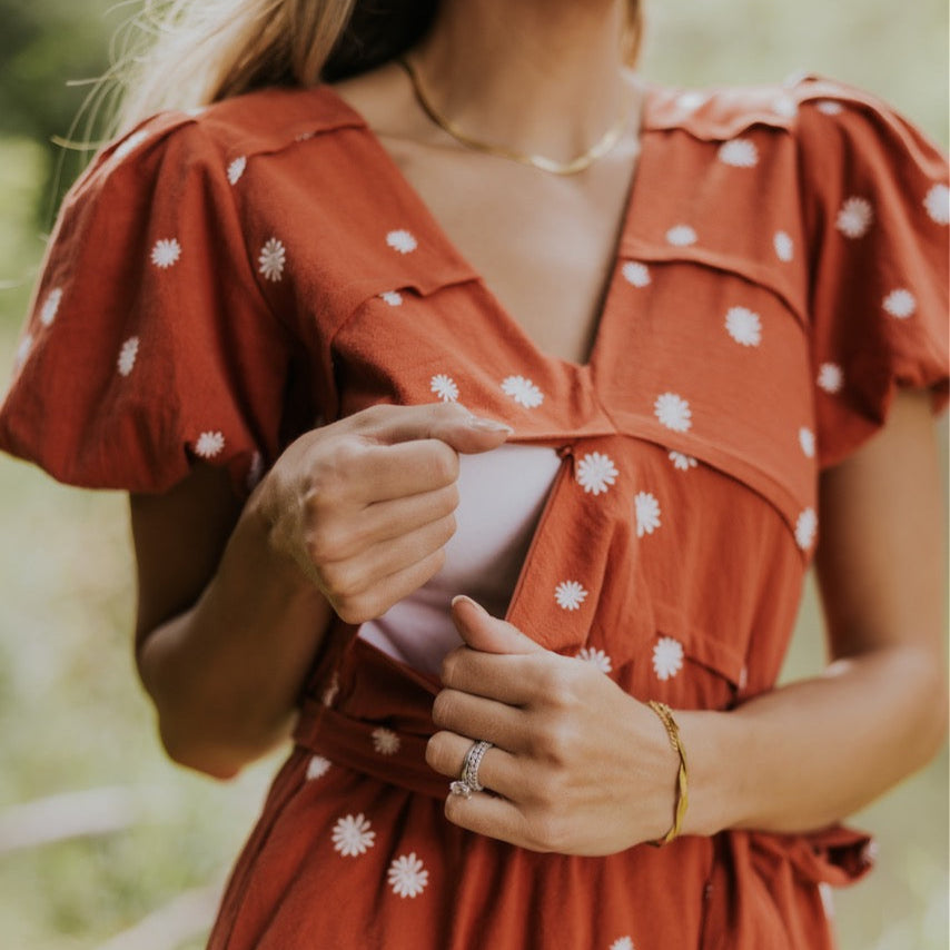 The perfect dress for the days when you need to channel your inner Lorelei Gilmore. Because who doesn't want to be a mom like her? I think I might just die over those puff sleeves, embroidered flowers, + crisp color. Don't forget to check out that discrete nursing zipper that's added to the bodice to create a stunning pattern. Make sure to tag us when you go to Luke's diner in this darling dress. Fire Brick