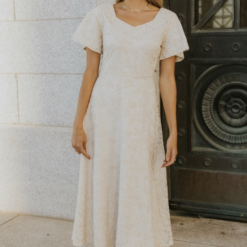 This one is going to sweep you off your feet. Featuring a sweetheart neckline, flutter sleeve, and flattering a-line silhouette. The embroidered floral overlay is a subtle yet captivating final touch to this timeless piece. This is one you will wear time and time again. Your holiday parties and special events won't know what hit them.