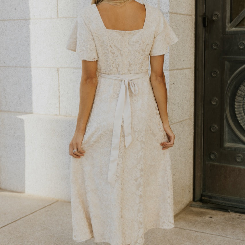This one is going to sweep you off your feet. Featuring a sweetheart neckline, flutter sleeve, and flattering a-line silhouette. The embroidered floral overlay is a subtle yet captivating final touch to this timeless piece. This is one you will wear time and time again. Your holiday parties and special events won't know what hit them.