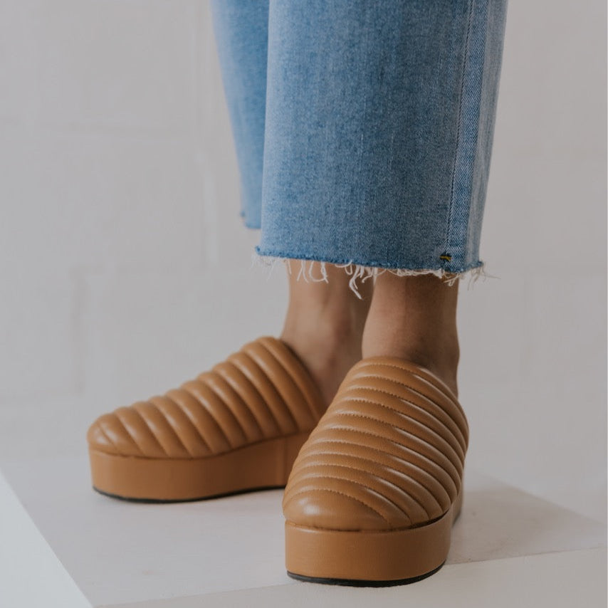 Our first thought for this shoe was 'foot couch' and here's why: quilted toe, platform design, + comfy footbed. It screams 'couch' for all the right reasons. This mule is basic but elevated. But be warned—it’s the kind of shoe that has people chasing you down the street to ask where you got it. And she pairs effortlessly with all your favorite looks from denim to dresses