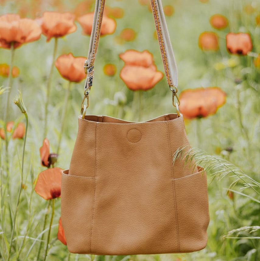 Casual + carefree crossbody in super-soft pebble grain vegan leather. The convenient side pockets carry your water bottle, phone, glasses, or mask. Available in two gorgeous colors that you can coordinate with interchangeable straps to personalize your style! peru