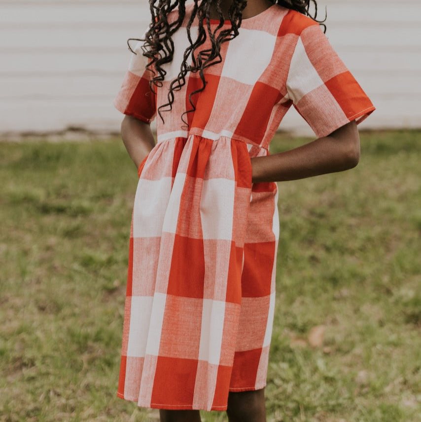 Now you and your mini can match in this ROOLEE classic! This dress features a timeless buffalo plaid that is bold, sophisticated and the perfect style for every occasion. Breathable, woven material is paired with hip pockets, half sleeves, a full lining, a gathered waist, and a flowing skirt. The Mini Maddie Buffalo Plaid Dress is adorable, versatile, and sure to be your daughter's favorite dress! Red
