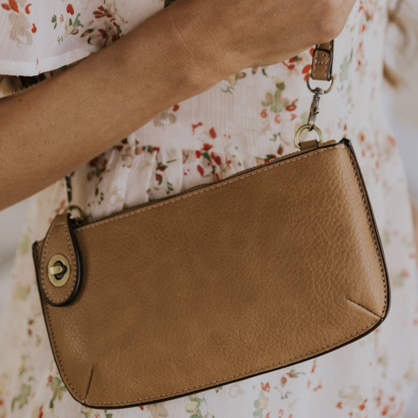 The Uptown Messenger Purse is perfection in a handbag! This versatile piece can be used as an adjustable cross-body bag, wristlet, or a simple wallet, making it the perfect finishing touch to any night out. A zippered top and rotating clasp closure are timeless elements that will make this the most functional purse you'll ever own!