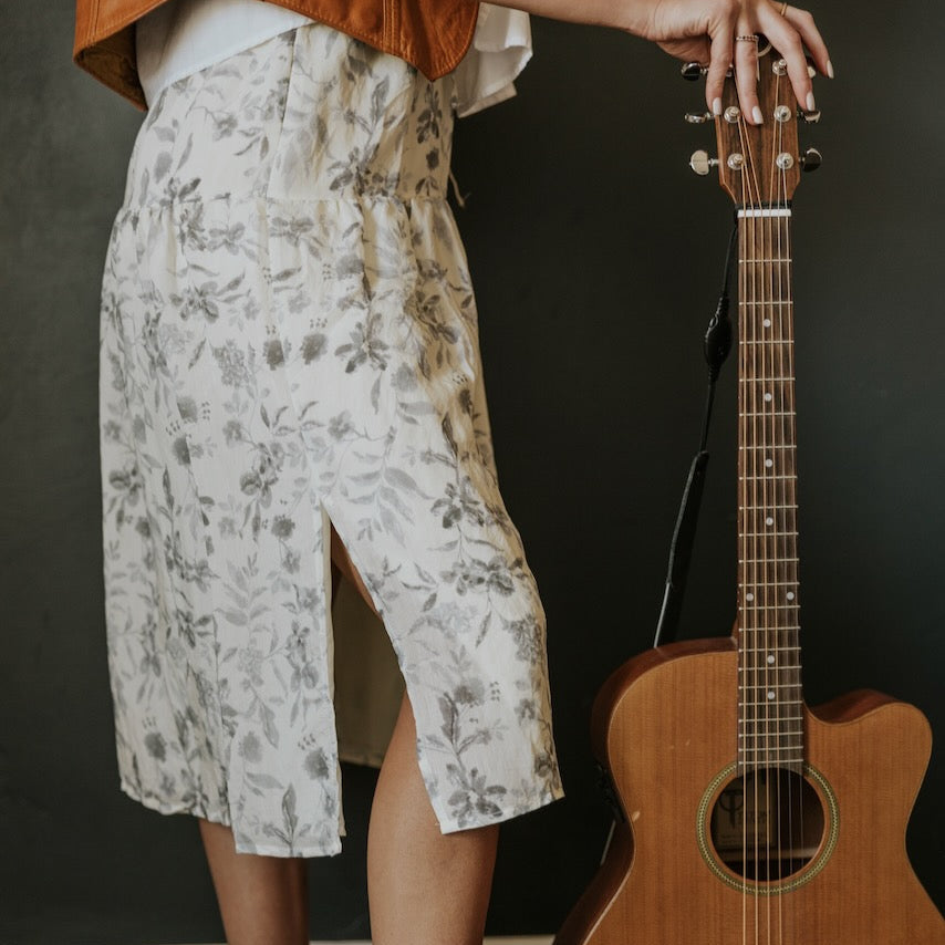 Crafted to comfortably drape, this skirt will contribute deeply to extraordinary combinations. Featuring dusty grey floral on ivory, tiered silhouette, and side slit. Pair her with blouses, graphic tees, or solid tops. For the every day and everything else, the Brookhaven Side Slit Tiered Skirt is going to be a closet superstar.