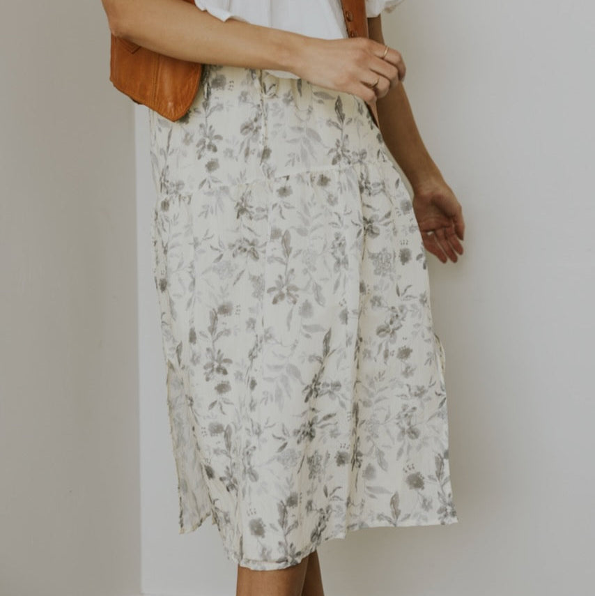 Crafted to comfortably drape, this skirt will contribute deeply to extraordinary combinations. Featuring dusty grey floral on ivory, tiered silhouette, and side slit. Pair her with blouses, graphic tees, or solid tops. For the every day and everything else, the Brookhaven Side Slit Tiered Skirt is going to be a closet superstar.
