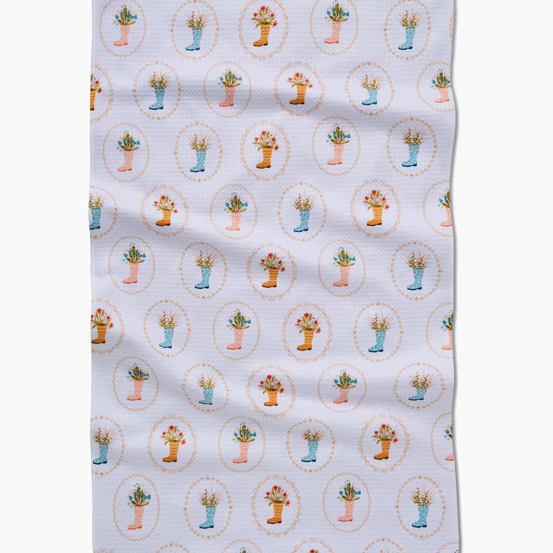 Patterned fabric with illustrations of cowboy boots as vases and flowers on a white background