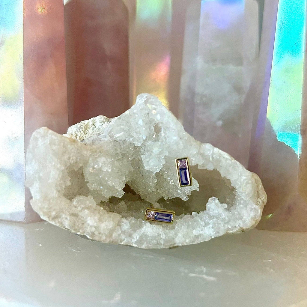 The Pleione Crystal Studs are inspired by the star in the Pleiades cluster. Called the Purple Pleione, it is known for its for being flattened due to spinning quickly. These earrings are perfect to add a pop of color to any stack!

• 925 sterling silver with gold plating

• Extra layer of tarnish resistance

• Purple cubic zirconia

• Curated by Mineral and Matter