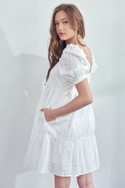 Get ready to turn heads in this quirky and playful Square Neck White Mini Dress! With its unique puff sleeve detail and flattering square neckline, this dress is perfect for any occasion. It's time to add a touch of fun and style to your wardrobe with this must-have piece.