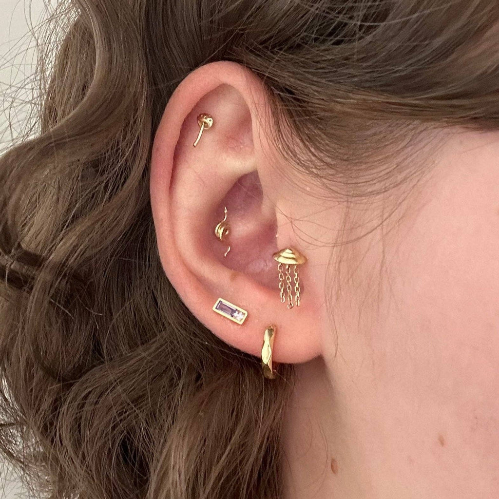 The Pleione Crystal Studs are inspired by the star in the Pleiades cluster. Called the Purple Pleione, it is known for its for being flattened due to spinning quickly. These earrings are perfect to add a pop of color to any stack!

• 925 sterling silver with gold plating

• Extra layer of tarnish resistance

• Purple cubic zirconia

• Curated by Mineral and Matter