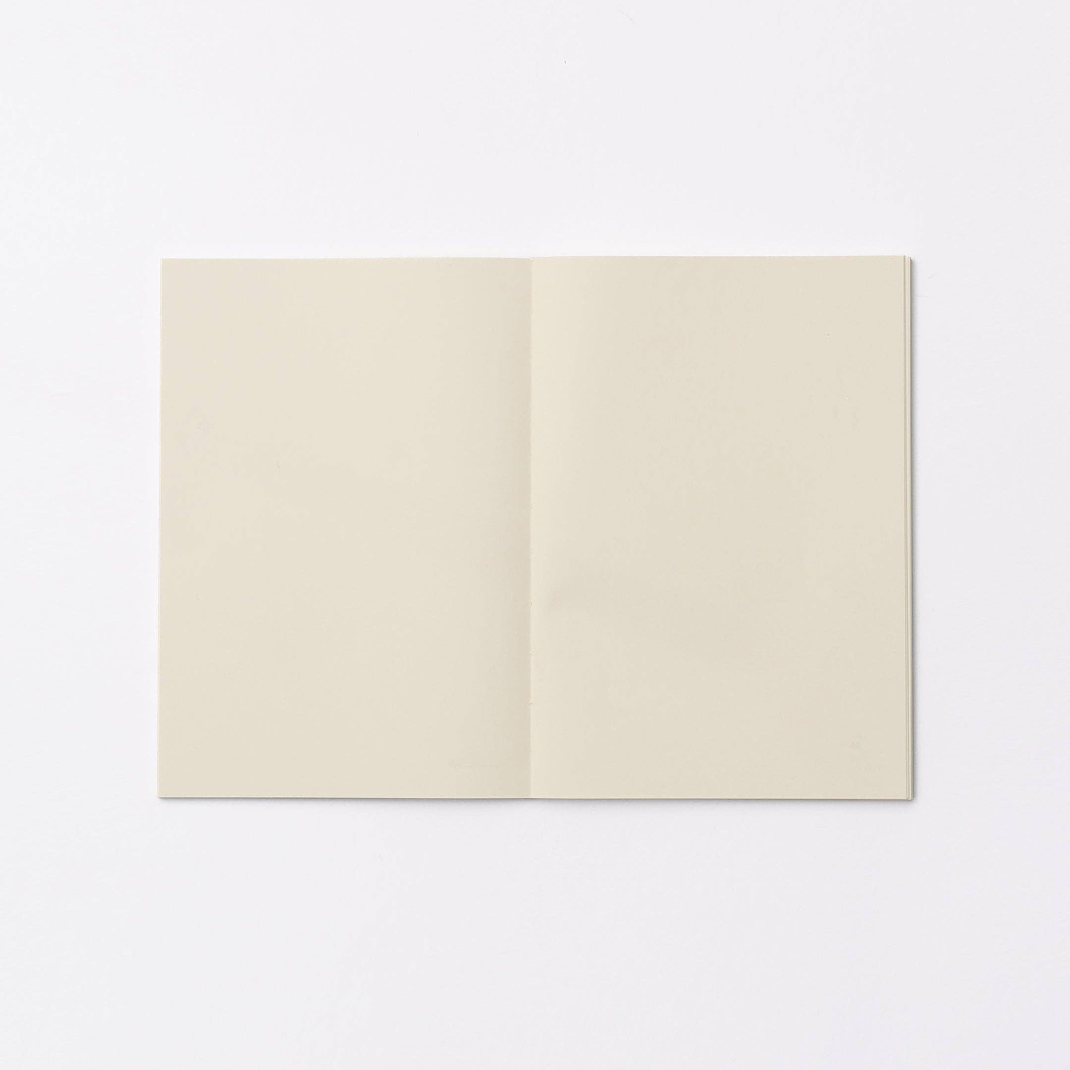 An open blank notebook or journal with cream-colored pages, displayed flat against a clean white background.