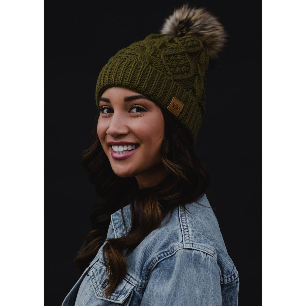 Add some sophistication and style to your cold-weather wardrobe with this muted olive cable knit pom hat featuring a floral patterned cuff! Ideal for breezy days, this hat will keep you feeling cozy and cute all season long.     Material  100% acrylic  Fleece lined