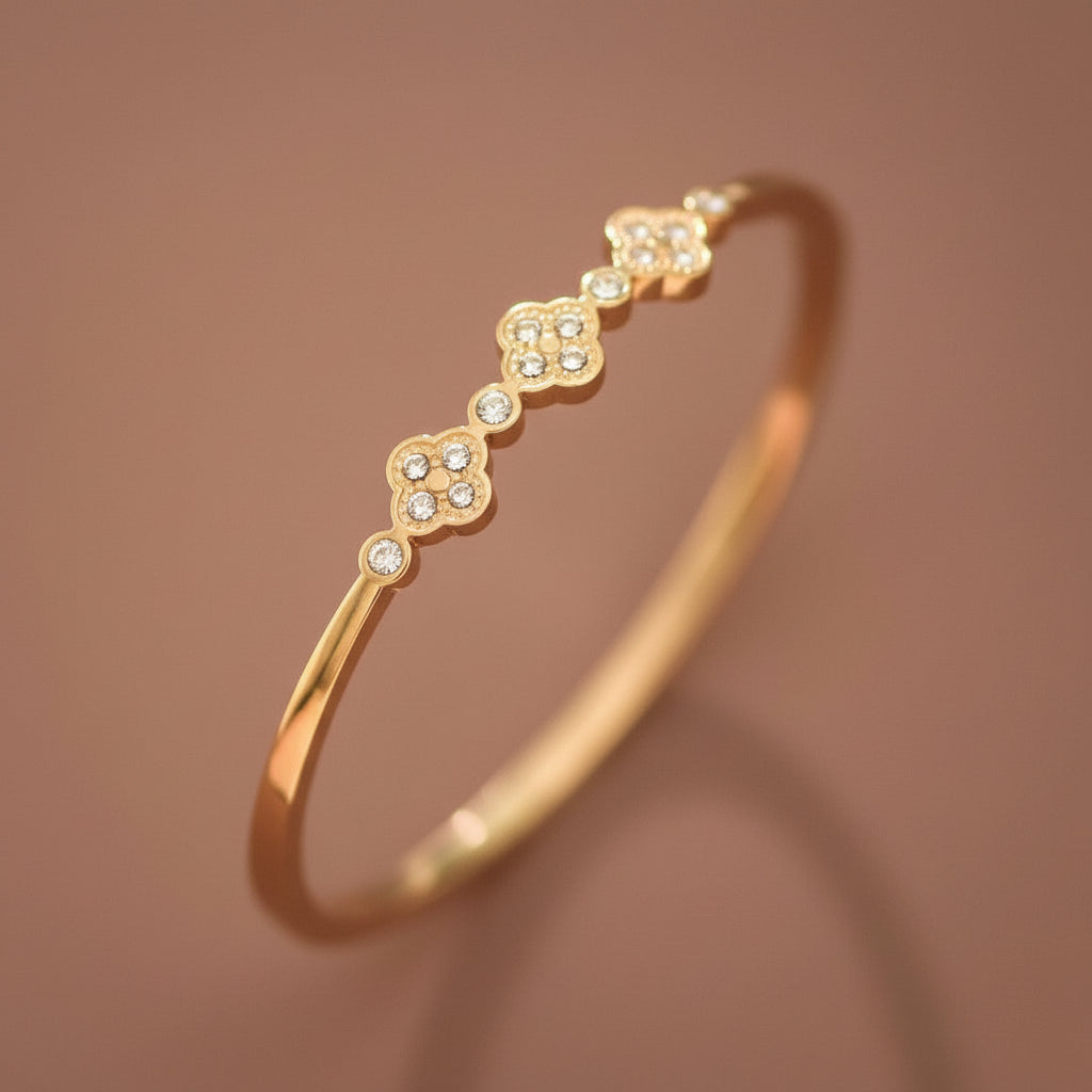 Elevate your everyday style with this 18K gold plated stainless steel bangle bracelet, featuring stunning inlayed crystals. With an inner oval diameter of 2.36", this piece combines luxury with practicality. Hypoallergenic, waterproof, and tarnish-resistant, it's designed to withstand daily wear. To maintain its radiant finish, avoid prolonged contact with lotions, perfumes, and cleaning products. A timeless accessory that transitions seamlessly from day to night.