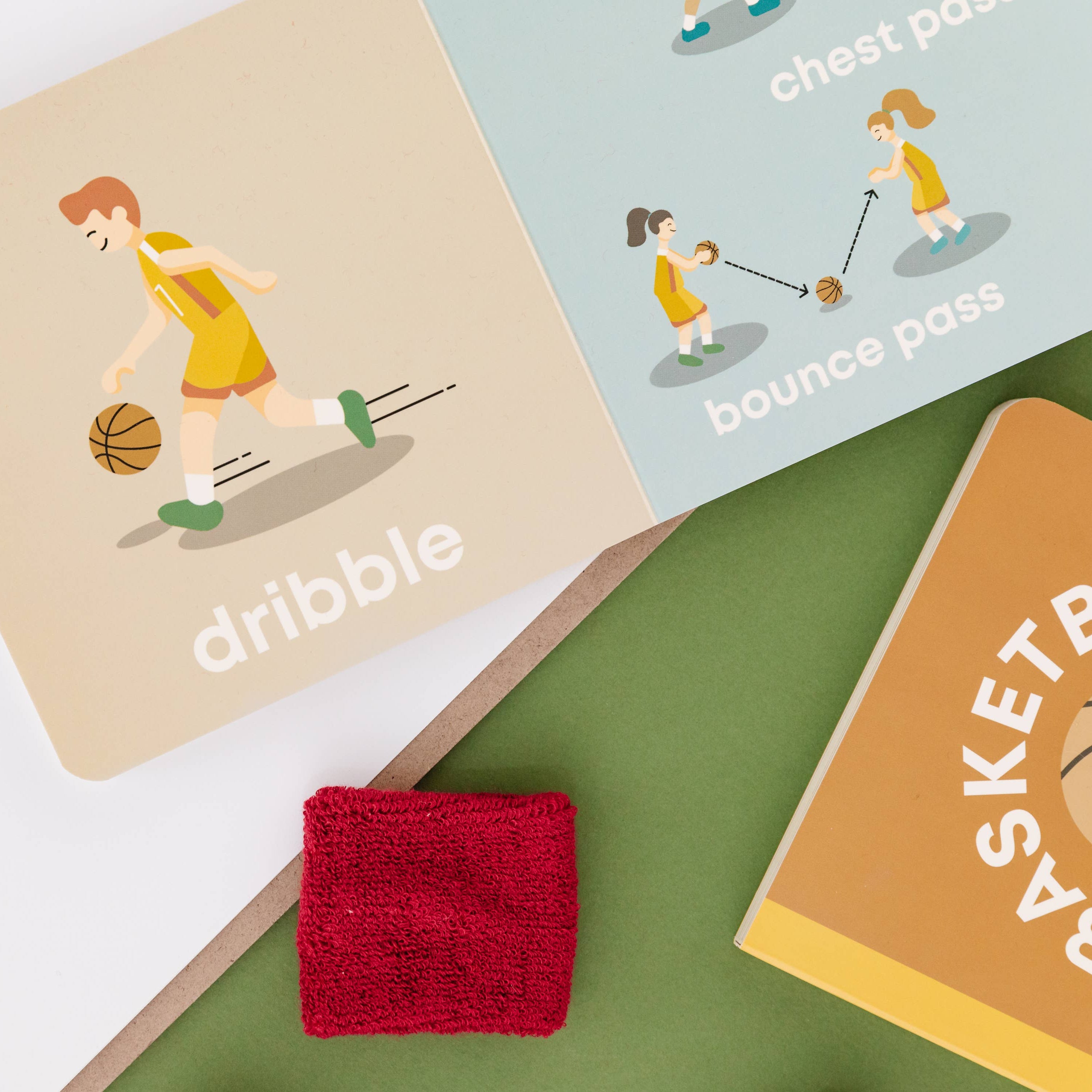 Educational cards about basketball with illustrations and text on a green surface.