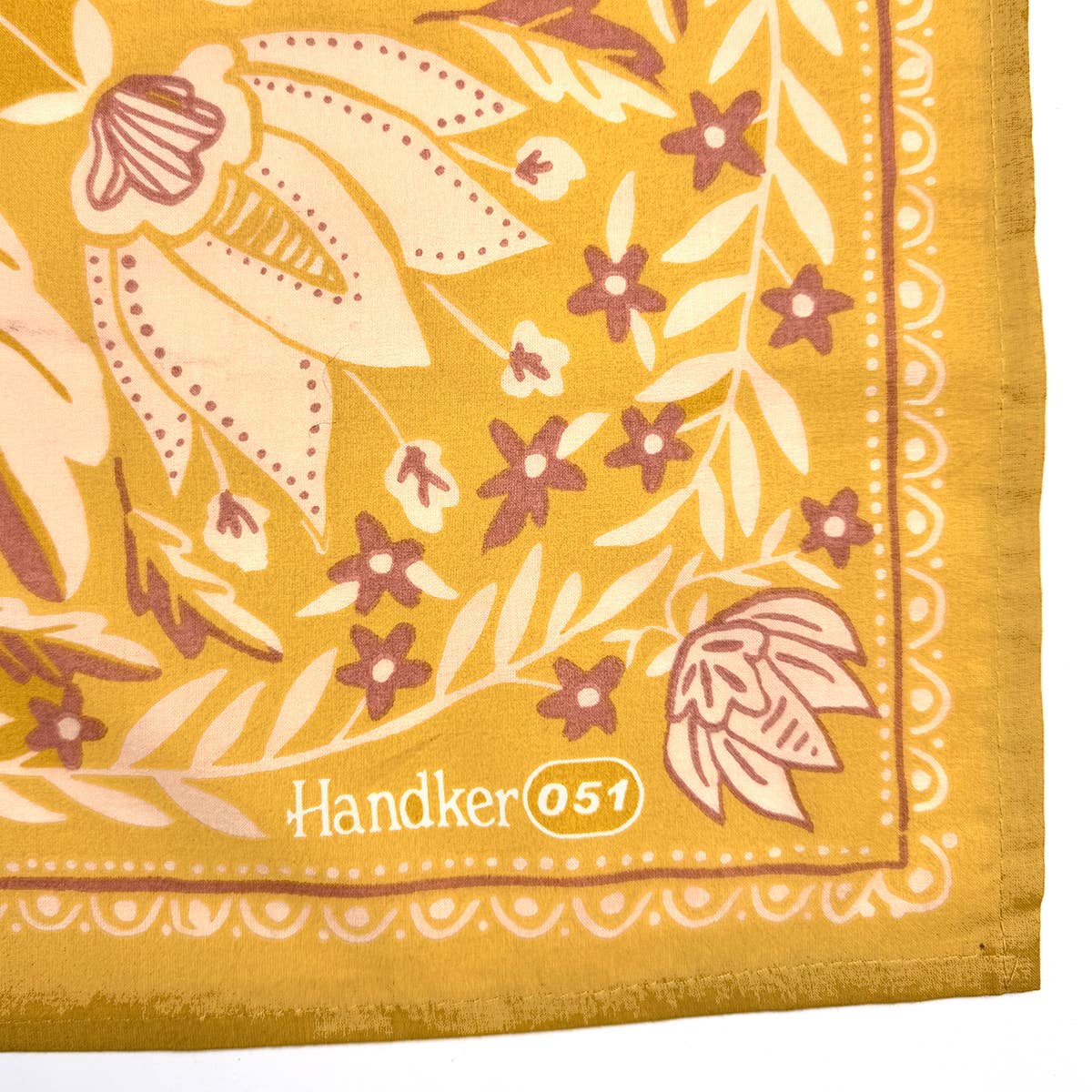 Yellow handkerchief with floral pattern and 'Handker 051' branding.