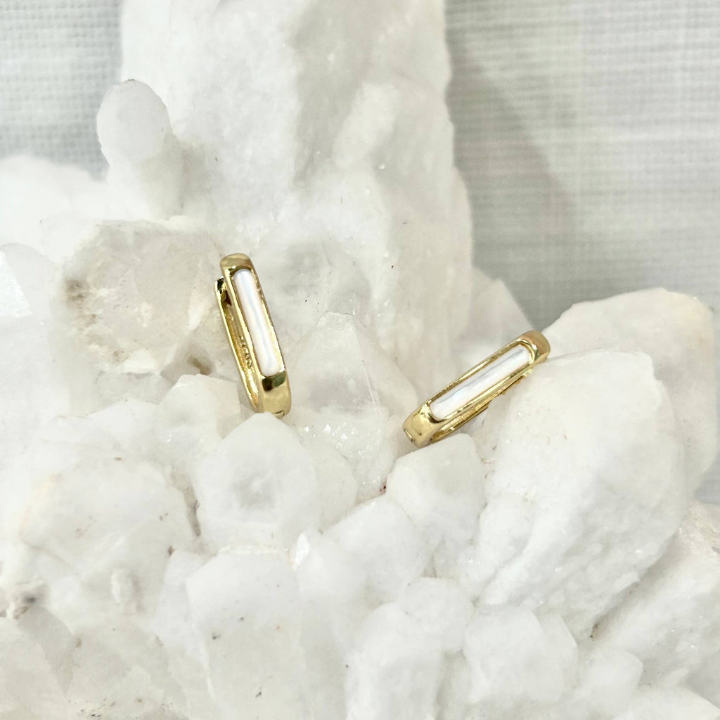 Mother of Pearl is often associated with creativity and prosperity. These unique and stylish huggie hoops are perfect for expressing your unique and creative self!

• 925 sterling silver with gold plating

• Extra layer of tarnish resistance

• Mother of Pearl Stone

• Manufactured for our curated collection.
