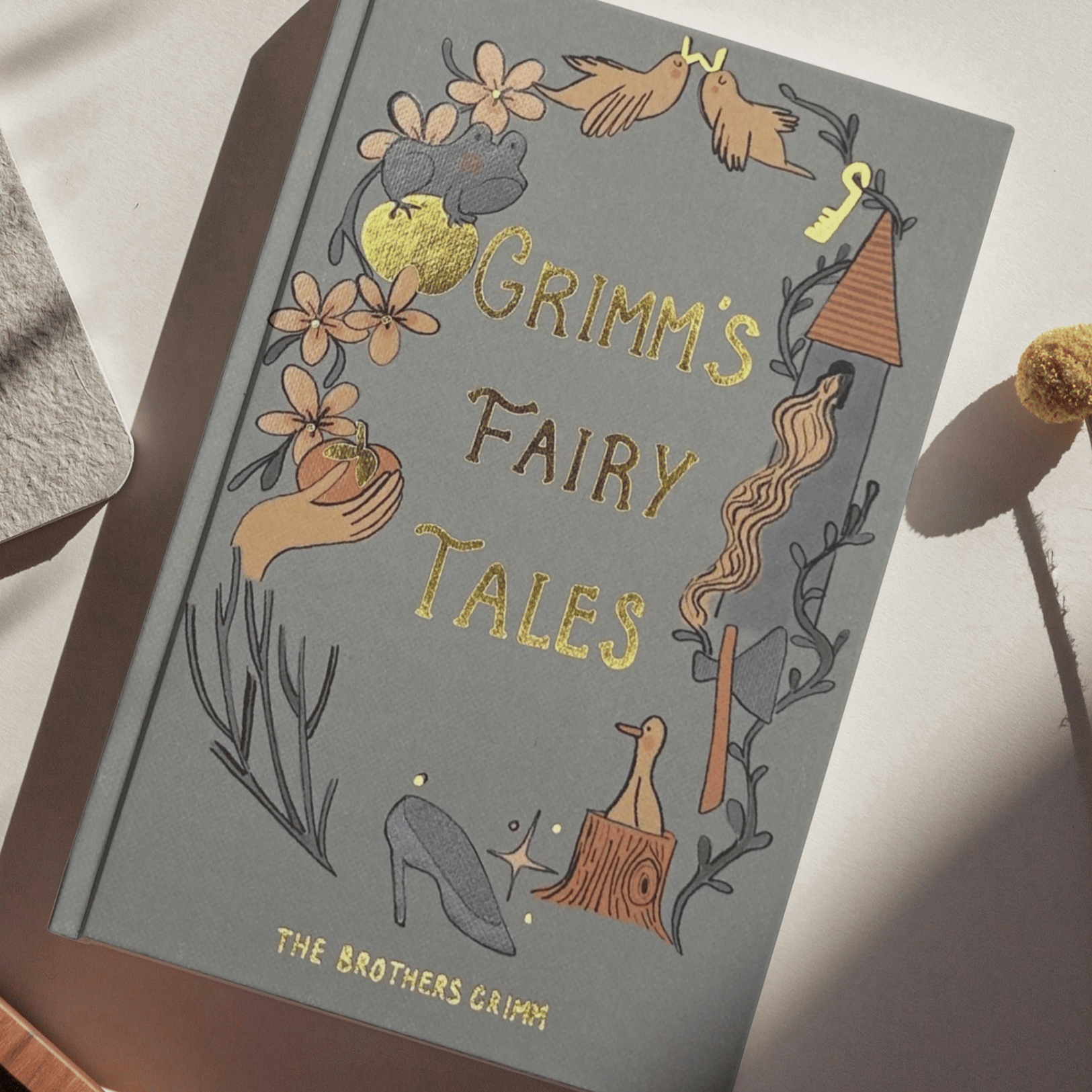 Book titled 'Grimm's Fairy Tales' with decorative cover on a light surface.