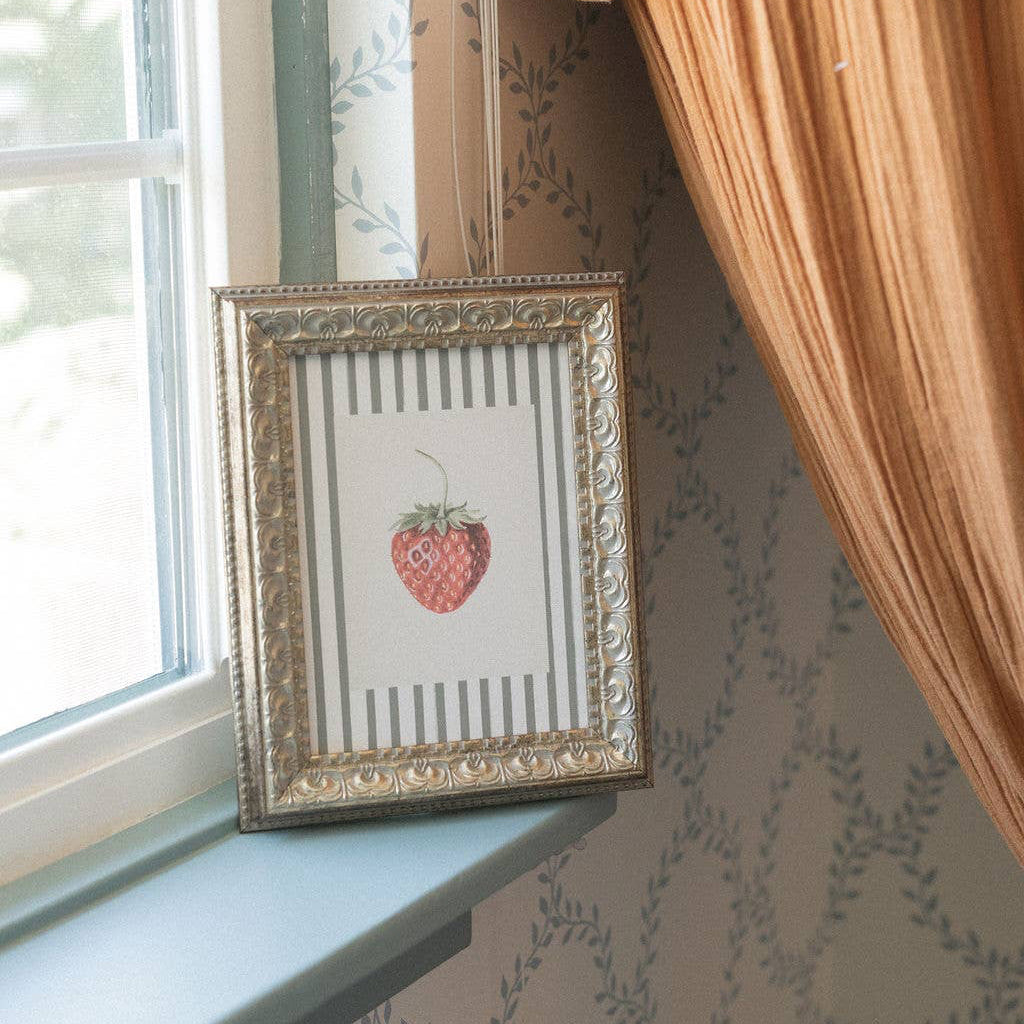 Bring timeless elegance into your home with this charming Strawberries on Stripes framed antique art. Printed on premium canvas fabric, this 8"x10" piece captures the warmth of vintage botanical design with a soft, textured finish that feels authentic and inviting. The handcrafted ornate frame adds classic character to any room, while the glass-free design keeps the artwork lightweight and lets the canvas texture shine through beautifully. Hanging hardware and paper backing are included. 