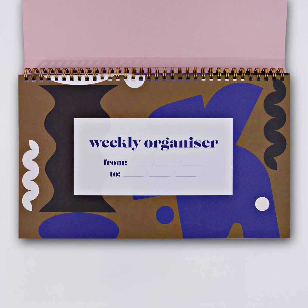 This undated weekly organizer features a weekly schedule with focused highlights and an organizer page designed to break down weekly tasks. It also has a tracker, a place to jot down weekly wins and space for notes too. The book features a 12 month overview spread, 53 weeks, and 3 notes pages at the back. This book has brass wire binding, 115gsm pages and a 300gsm cover. It measures 29.7cms wide and 17.8cms high. Made in the UK.