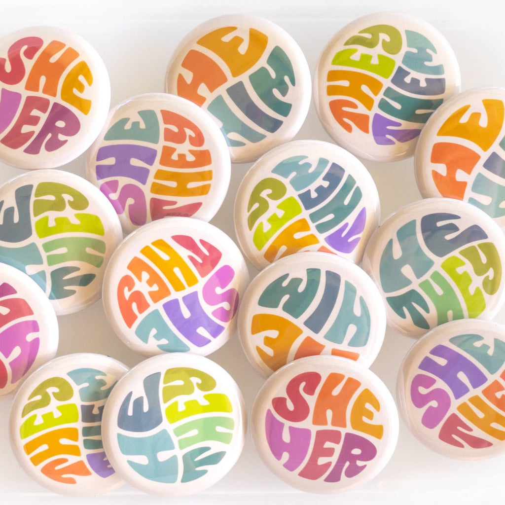 Wear your pronouns with pride with these cute retro-style buttons! This pinback button displays "He/They" pronouns in a green and blue color palette. It is the perfect way to let others know how to address you and to show your support for the LGBTQ+ community!  Size: 1.25" pinback button