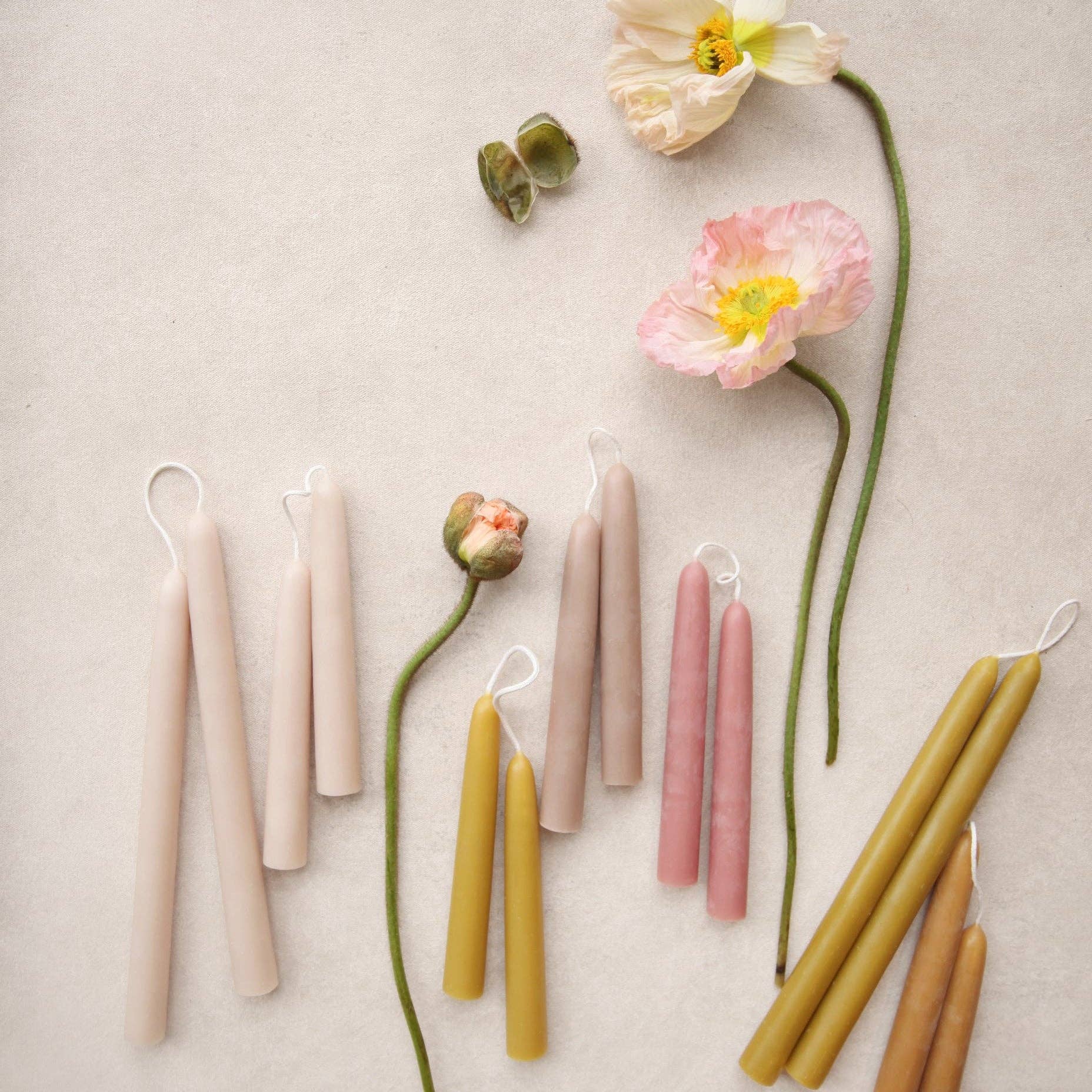 Colorful candles and flowers arranged on a light background