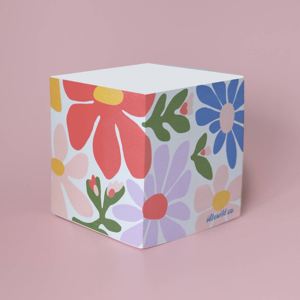 Floral patterned cube on a pink background