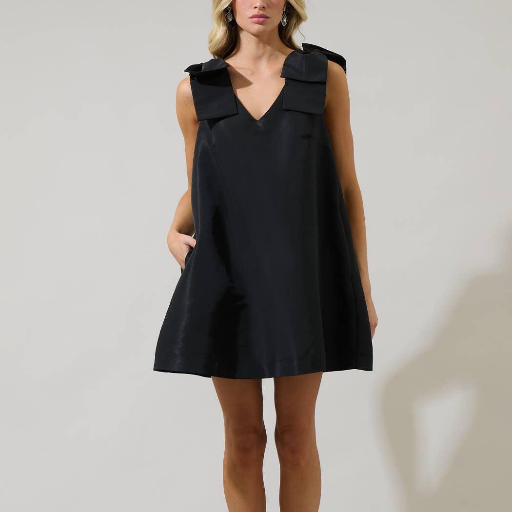 Get ready for an ultimate sassy look with this Alani Bow Trapeze Mini Dress. A shoulder bow detail frames a v neckline with a sleeveless look. The body has a trapeze style, creating a loose effect. Wear it with strappy heels and you’re good to go.

Details:

Ribbon detail
Trapeze sleeveless
Zipper
Mini
Model is 5'9" and wearing size XS
Measurements taken from size S - Chest: 19 3/4" - Length: 33 1/2"
Color: Black