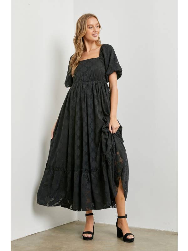 Get ready to bloom in this Black Floral Woven Maxi Dress! With a playful floral print, this dress is perfect for any spring or summer occasion. The flowy maxi silhouette is both comfortable and stylish, making it a must-have addition to your wardrobe. Upgrade your style with this quirky and fun dress.