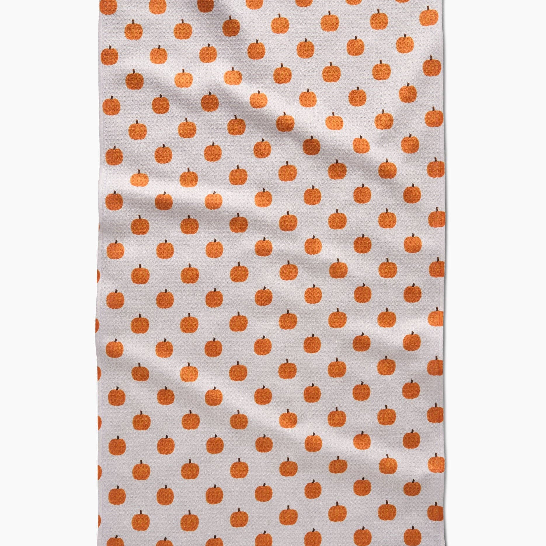 Tea towel with orange pumpkin pattern on a white background