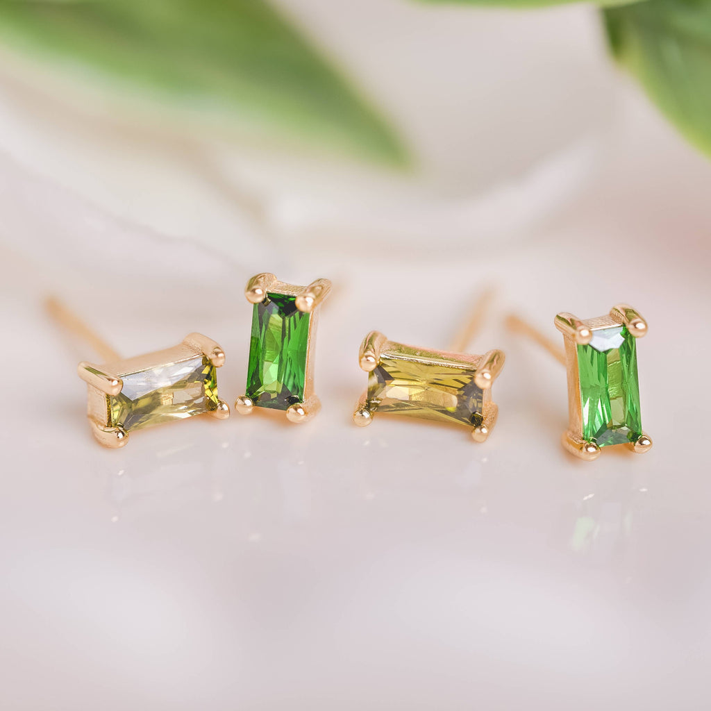  Birthstone Ombre Baguette Stud Earring Set, a collection of four stunning earrings crafted in 18k gold plated with an anti-tarnish coating. This set of stud earrings showcases the ombre effect, seamlessly blending hues from light to dark, creating a captivating visual representation of your birthstone's color spectrum. 