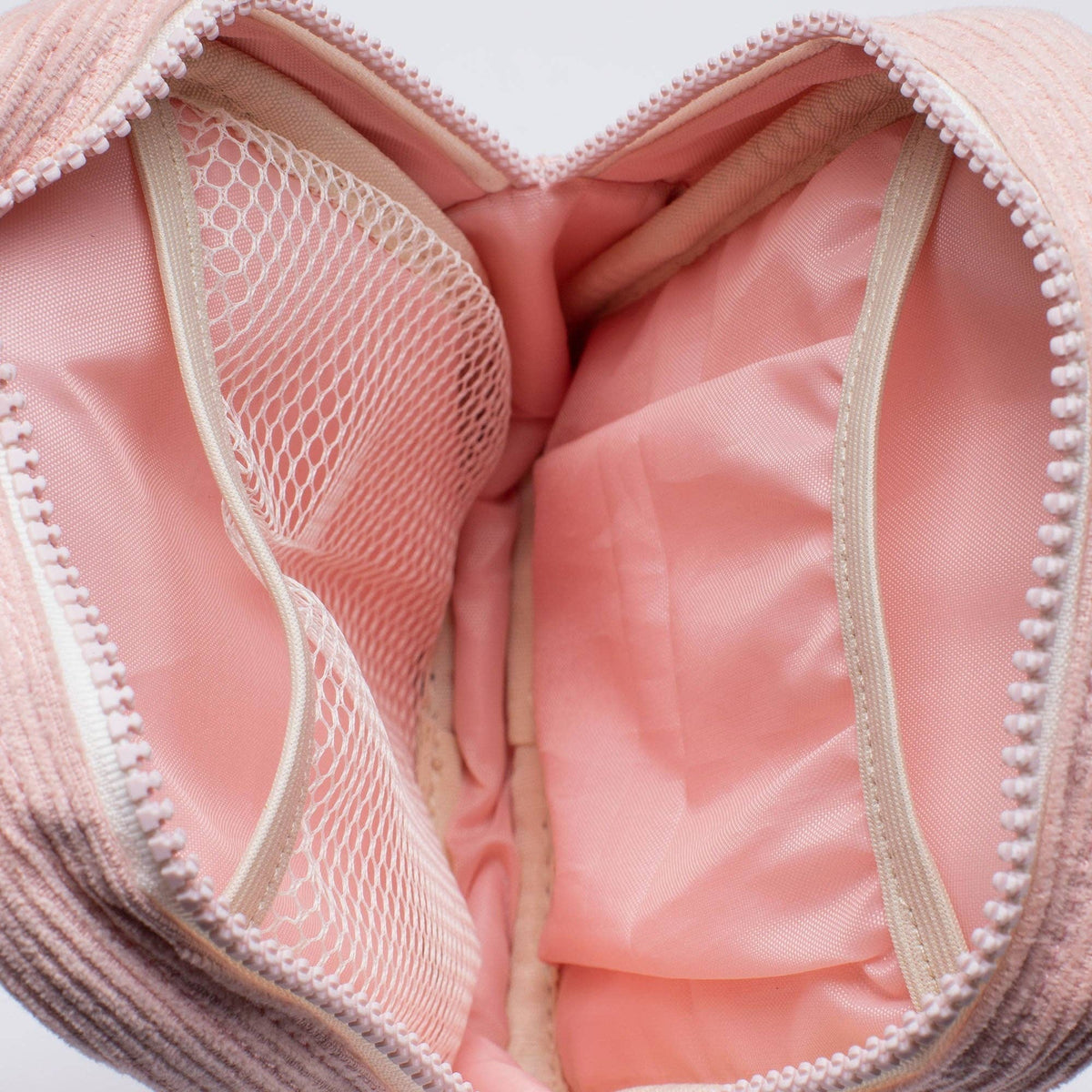 Close-up of a pink bra with mesh lining on a white background