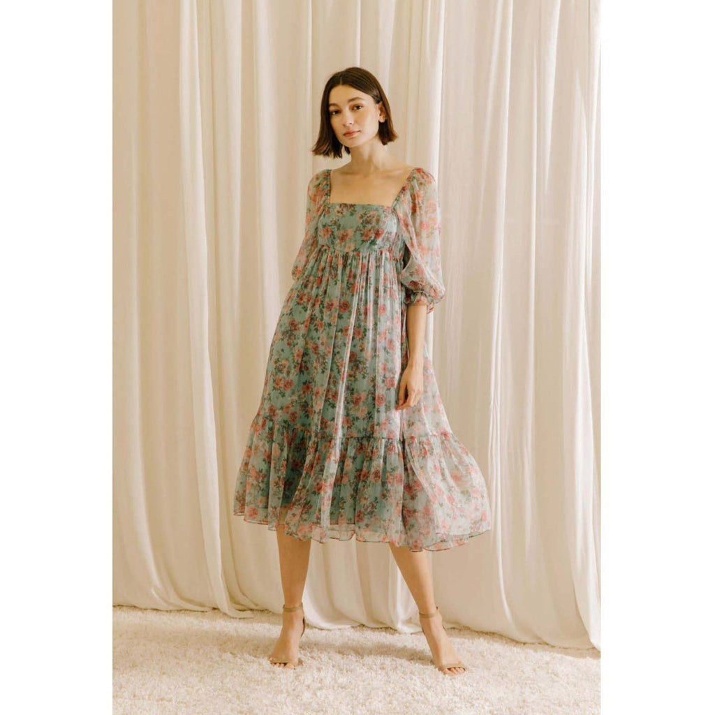 Rose floral print midi baby doll dress. It shows a square neckline, 3/4 sleeves, and bust darts. It also has a gathered empire waist, ruffled hem, and an invisible zipper.