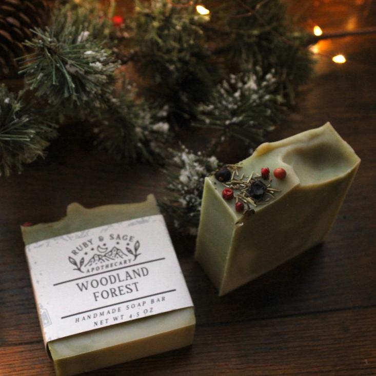 green bar soap with herbs and berries. This soap is scented in a woodsy blend of Copaiba Balsam, Pine, Eucalyptus, Cedarwood, and Cypress therapeutic grade essential oils. 
