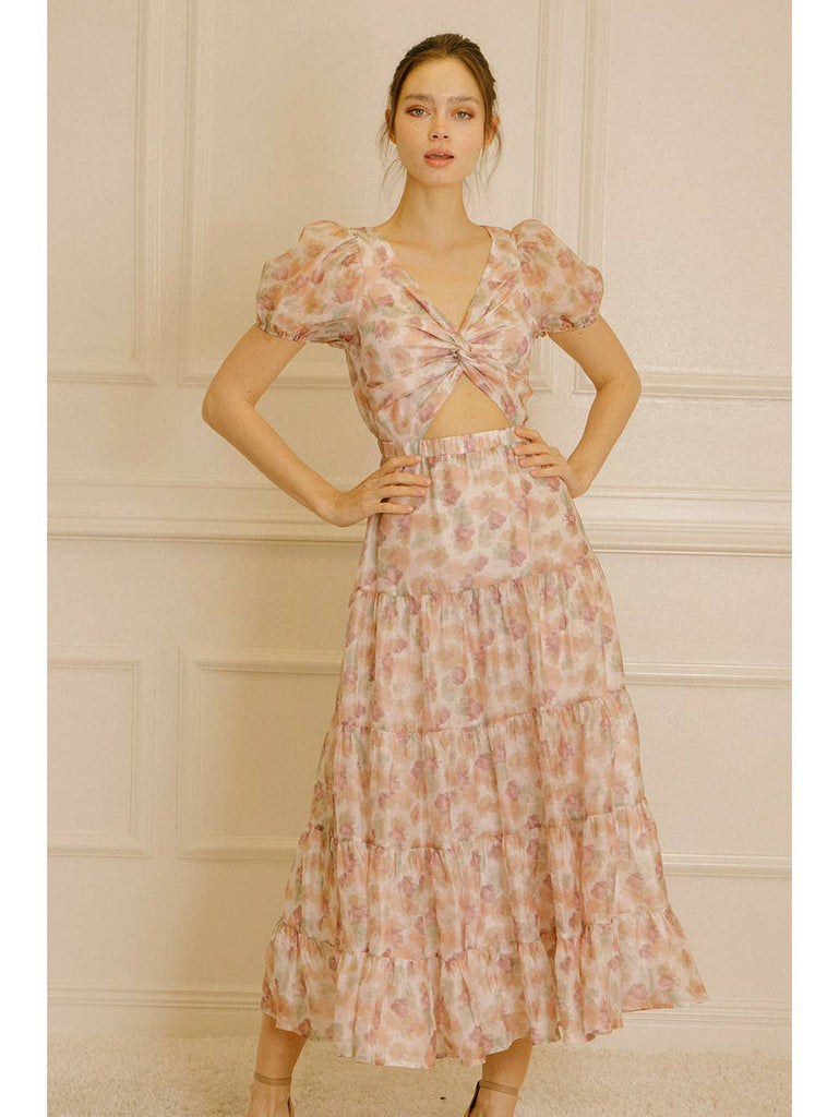 Water-painted floral ruffled midi dress. It displays a V neckline, short puffy sleeves, and a wrapped, ruched center. It has an upper torso peephole, high elastic cinched waist, and ruffled flowy midi bottom.