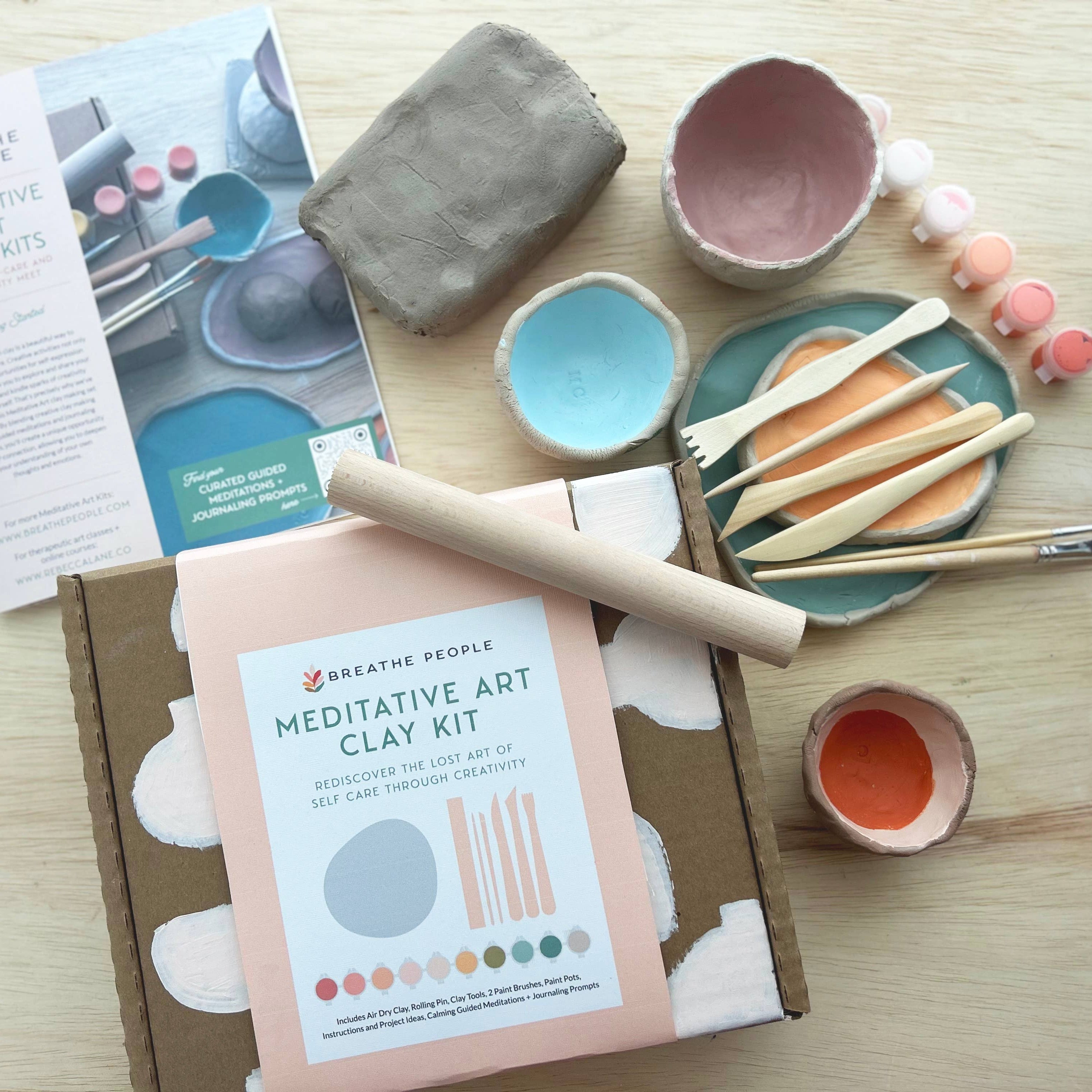 Meditative Art Clay Kit with clay, tools, and packaging on a wooden surface