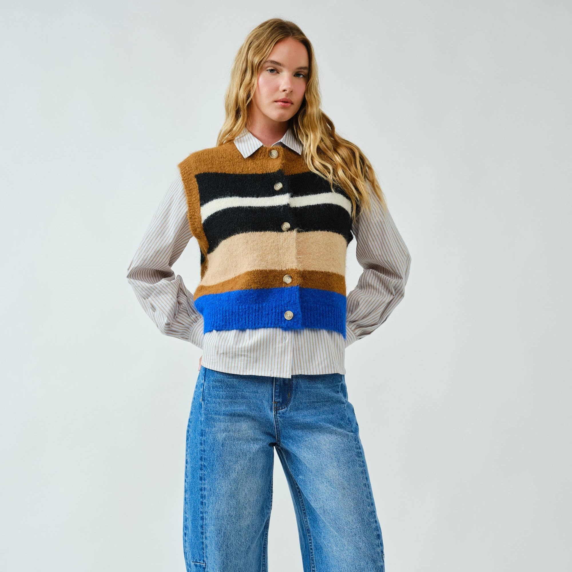 Cozy up in bold style with this soft pullover sweater vest, designed with striking multicolor stripes. The fuzzy knit texture adds warmth, while the relaxed fit and button-down front offer a laid-back, vintage-inspired feel. Whether layered over a shirt or worn on its own, this vest delivers both comfort and standout personality.
