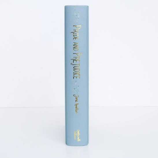 Blue book titled 'Pride and Prejudice' by Jane Austen on a white background