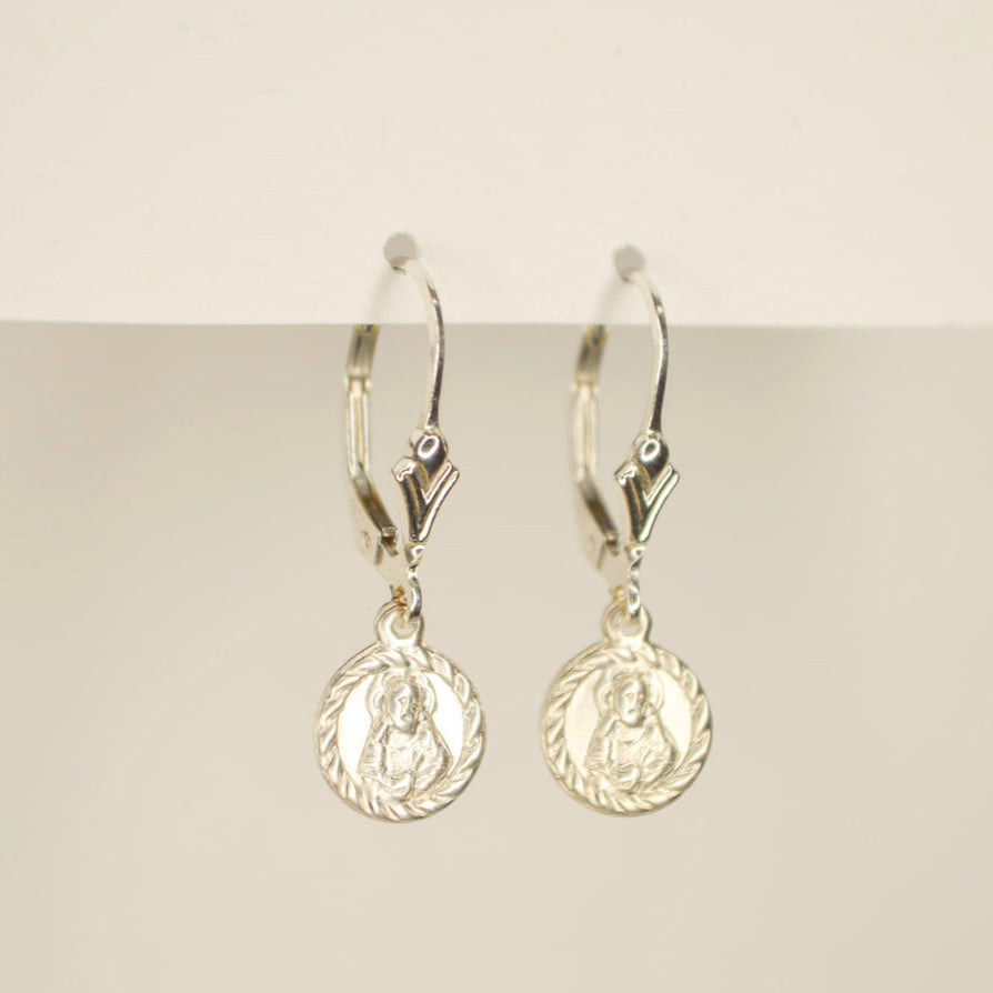 silver leverback earrings with a small silver circle token on a white back ground.