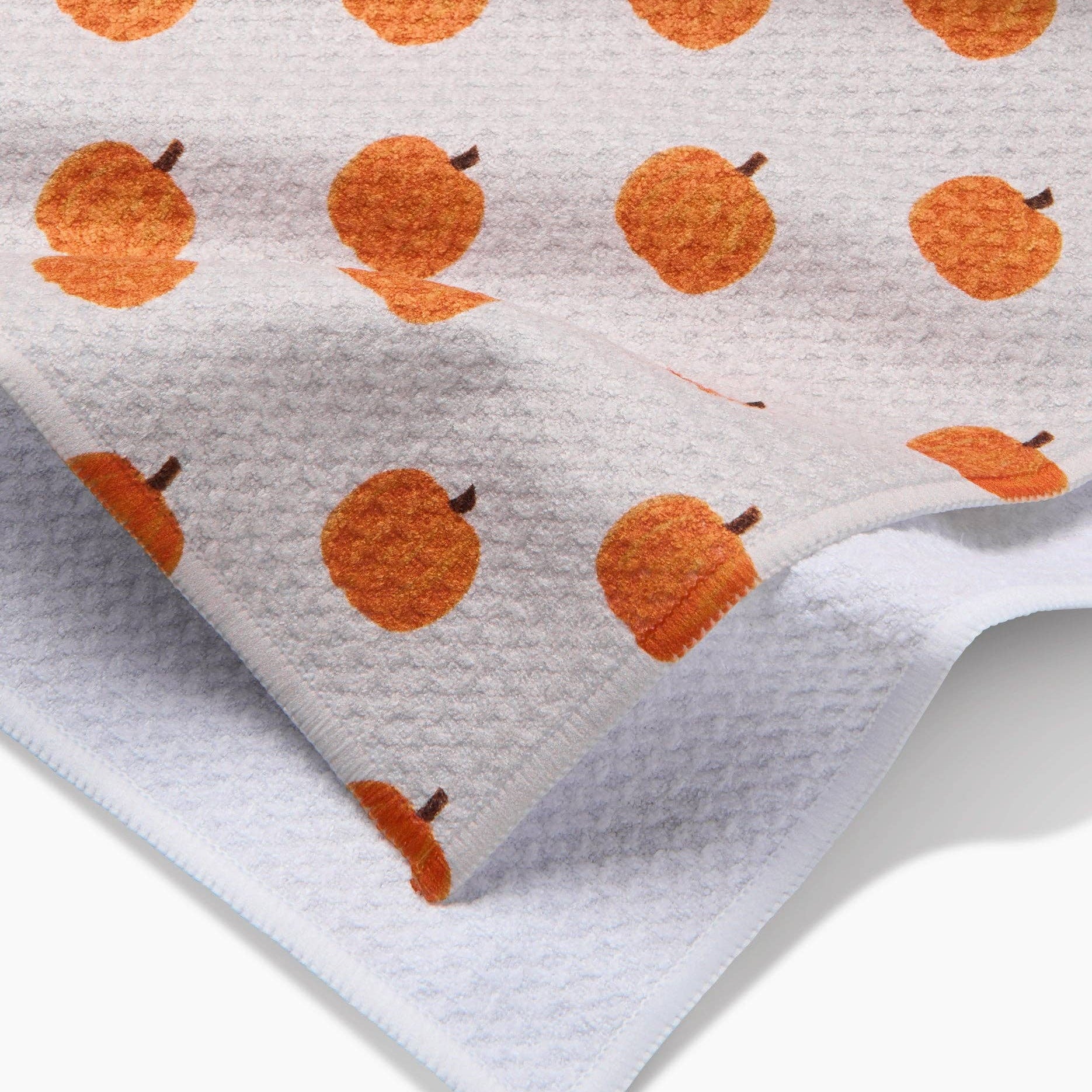 Fabric with orange pumpkin pattern on a white background
