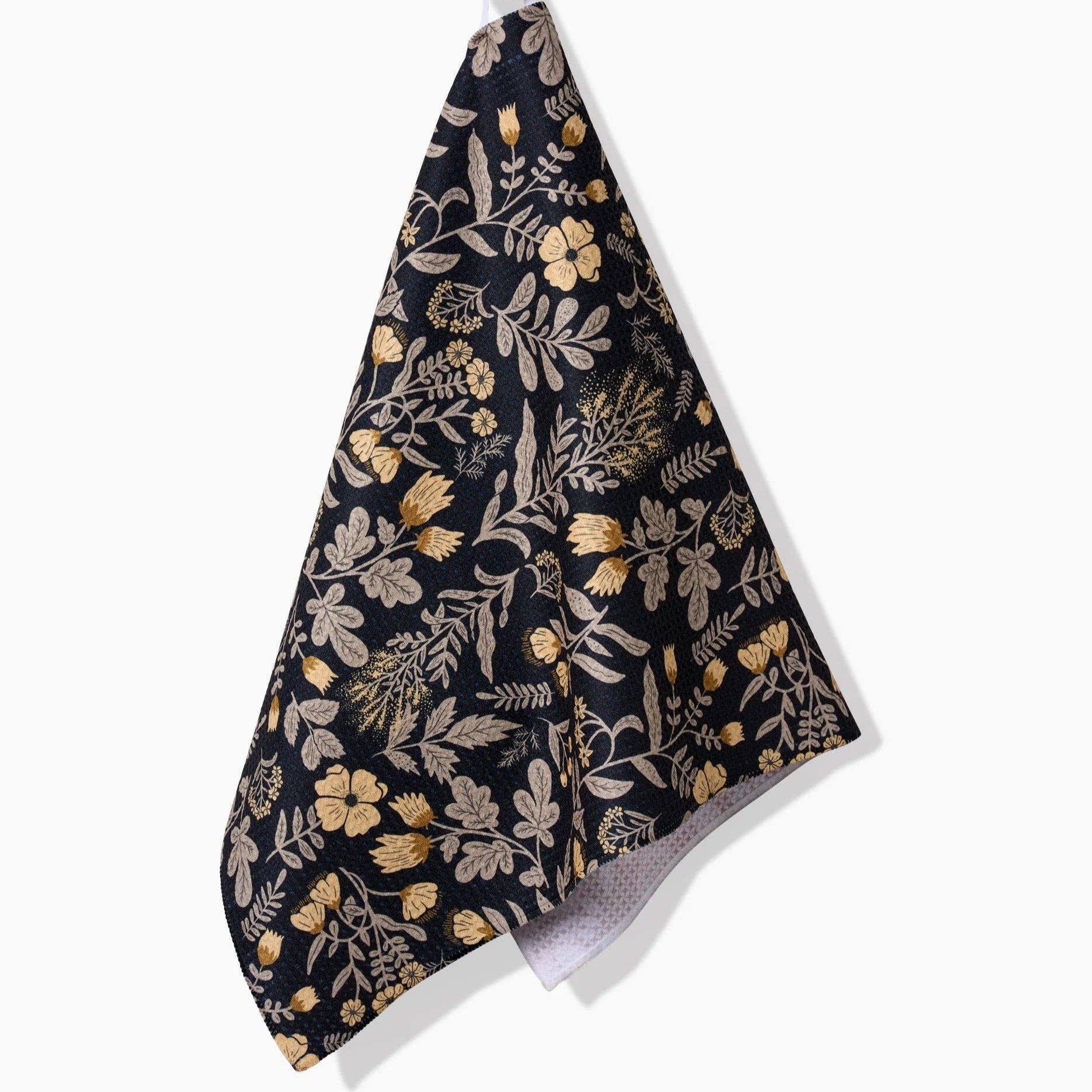 black tea towel with yellow/green floral pattern