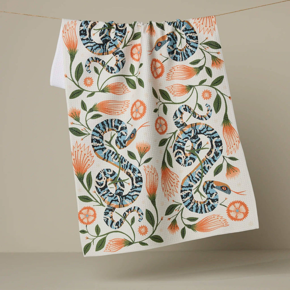 Tea towel with snake and floral pattern on a beige background