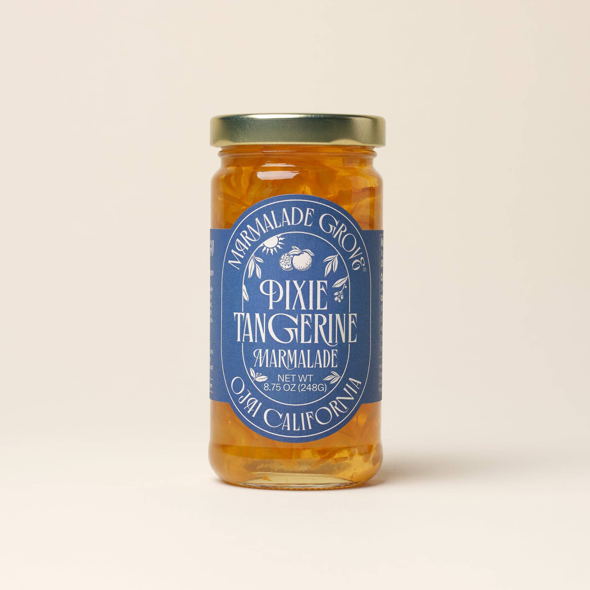 Jar of Pixie Tangerine Marmalade from Marmalade Grove on a beige background