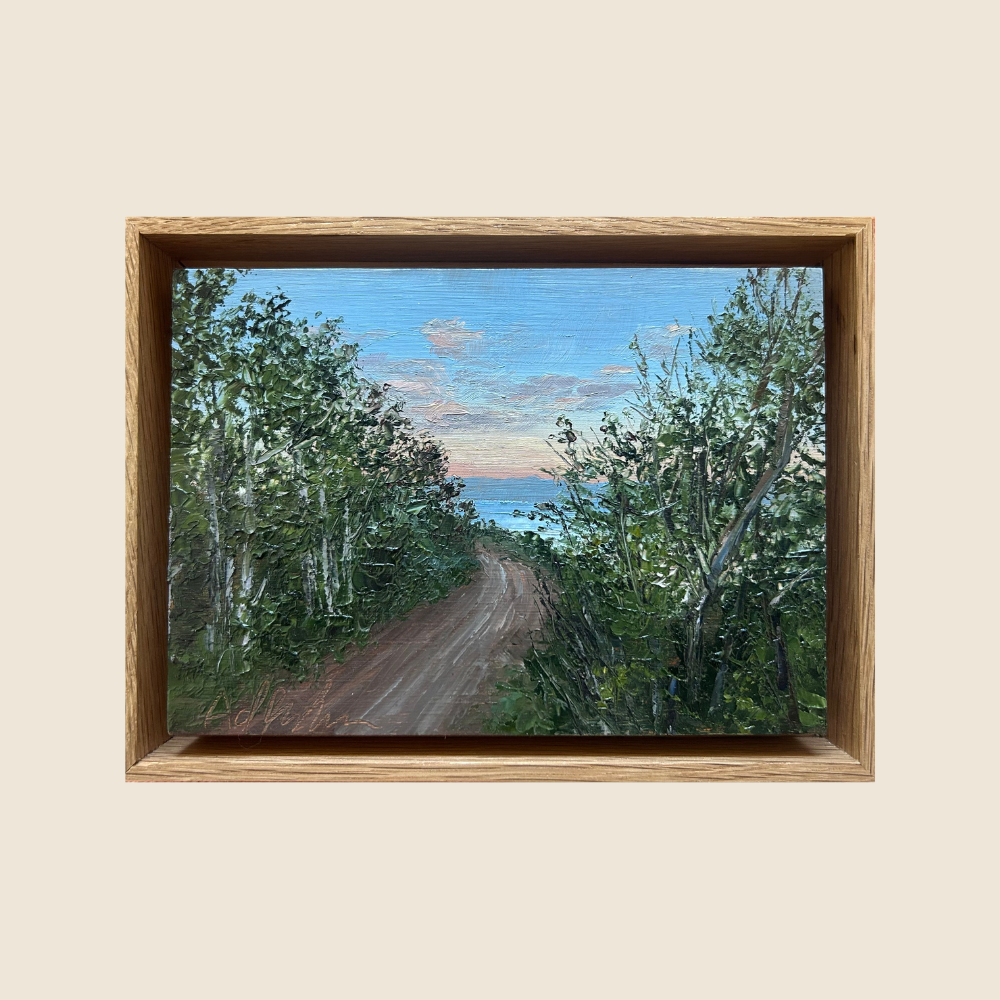 Mountain Trail through Trees, with a slice of the blue Bear Lake on the horizon.  Candy colored clouds in the blue sky.