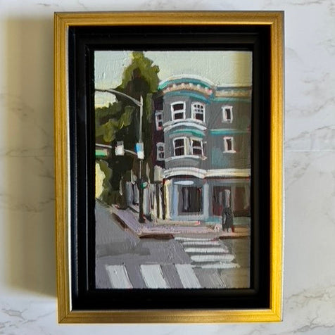 Framed artwork of a building on a marble wall