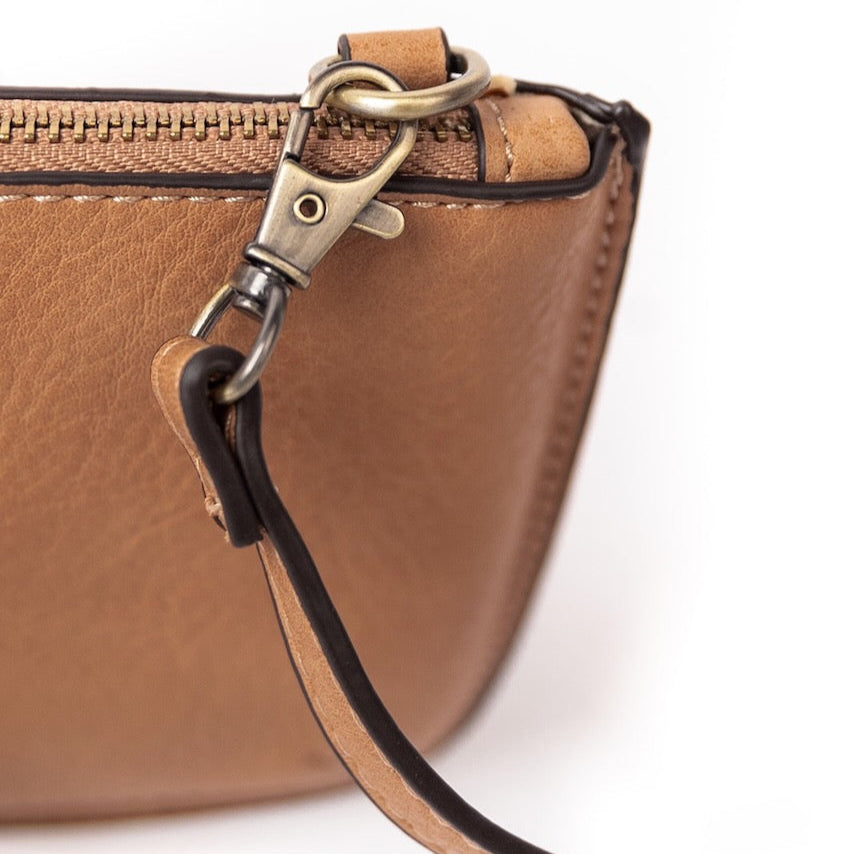 The Uptown Messenger Purse is perfection in a handbag! This versatile piece can be used as an adjustable cross-body bag, wristlet, or a simple wallet, making it the perfect finishing touch to any night out. A zippered top and rotating clasp closure are timeless elements that will make this the most functional purse you'll ever own!