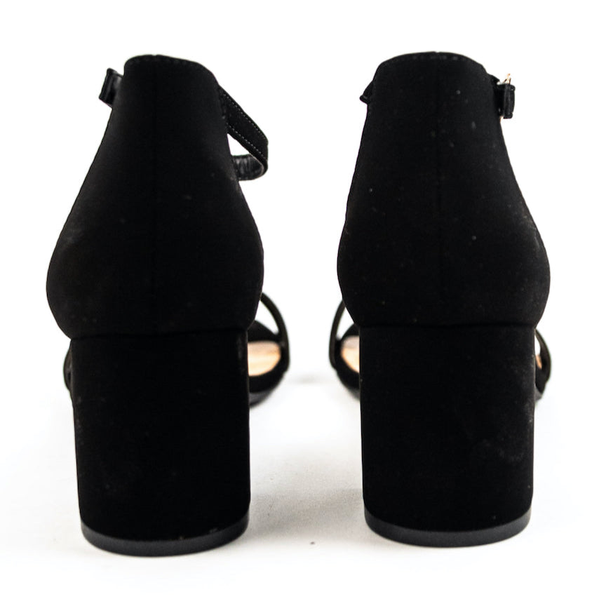 The perfect summer heels for the everyday boss babe! These faux suede heels are designed with a block heel, an ankle strap, and a strap that goes over your toes & Wear with your linen trousers, flowy skirts, or favorite dresses, these heels can bring every outfit to new heights! Black