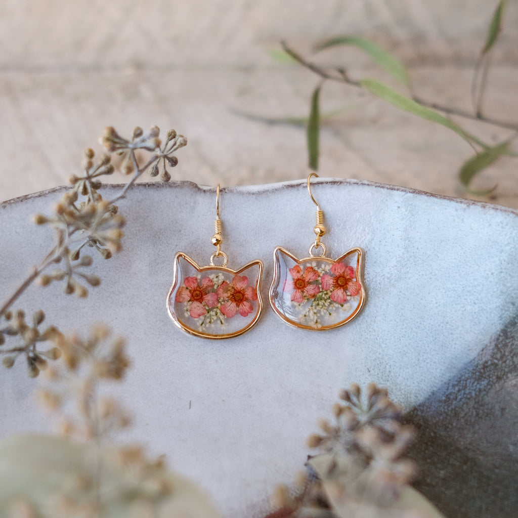 gold, cat shaped earrings with red hand pressed flowers